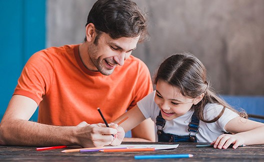 father and daughter doing art activity