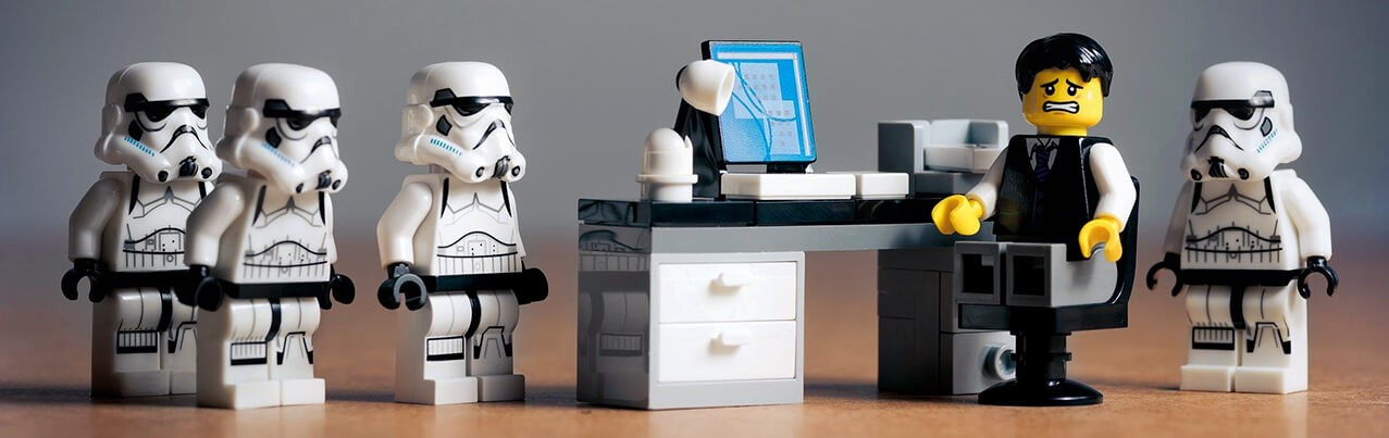 lego man at desk with stormtroopers
